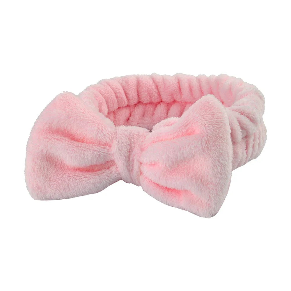 Pink microfiber spa headband and wristband set with a fluffy texture