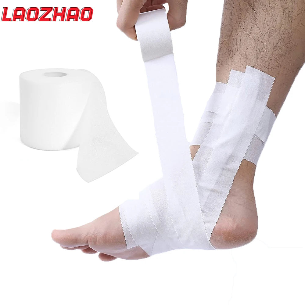 Roll of white athletic support tape being applied to a person's ankle and foot.