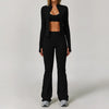 A woman models a black 3-piece yoga sports set consisting of a long-sleeved top, high-waisted leggings, and a matching jacket