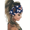 A woman wearing a navy blue floral butterfly headband with blonde hair.