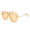 A pair of gold-toned fashion protective sunglasses with clear lenses and thin metal arms.