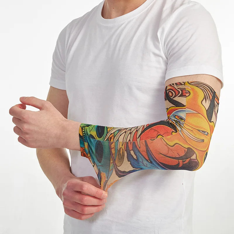 A person is wearing a colorful, artistic arm sleeve on their forearm while holding it.