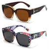 A pair of oversized brown sunglasses with gold accents and a pair of dark purple floral patterned sunglasses.