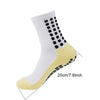 White and yellow grip socks with black dots on the ankle, shown from the side.