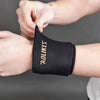 A hand is putting on a black knee sleeve for hot and cold therapy.