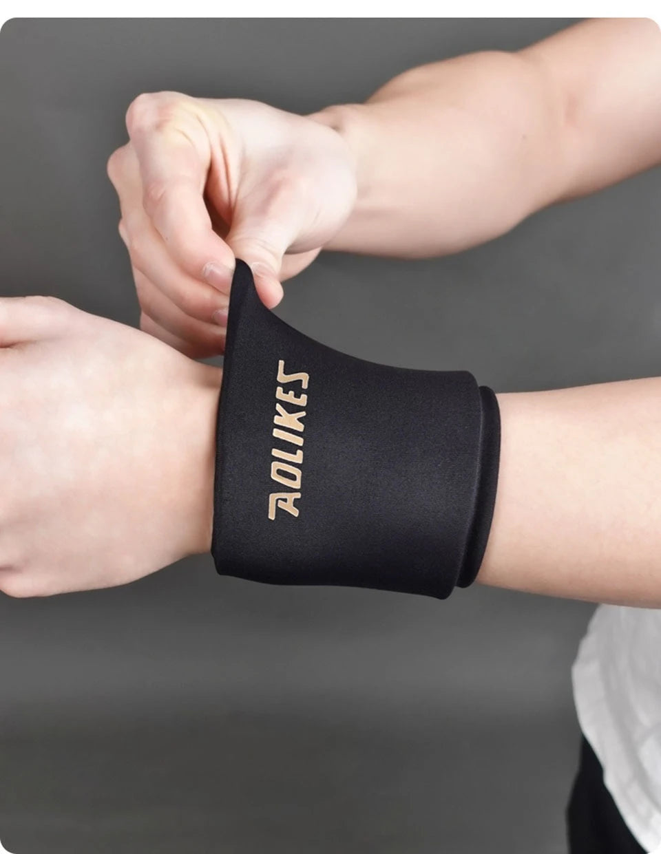 A hand is putting on a black knee sleeve for hot and cold therapy.