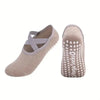 A pair of beige silicone anti-slip pilates and yoga socks shown from the side.