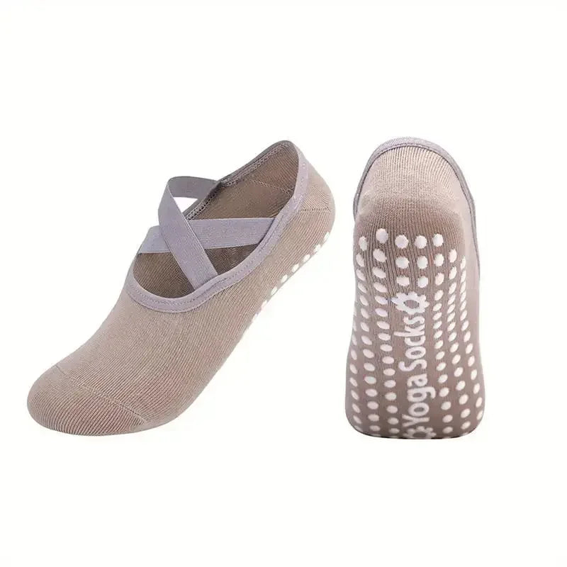 A pair of beige silicone anti-slip pilates and yoga socks shown from the side.