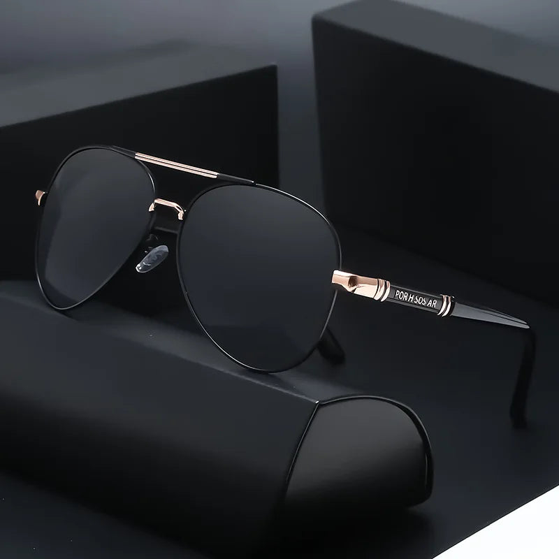 A pair of black polarized sunglasses with gold accents resting on a dark surface.