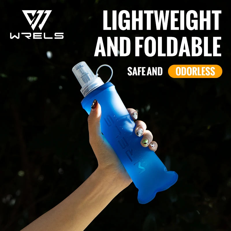 A hand holds a lightweight, foldable blue silicone hydration flask against a dark, blurred background.