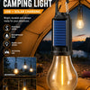 A solar camping light lantern with a glass bulb is shown inside a tent setting.