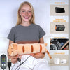 A young woman holds a beige heating pad and an accompanying USB charger for muscle relief.