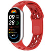 A red silicone smart watch band with a silver casing and a black digital display showing health metrics.