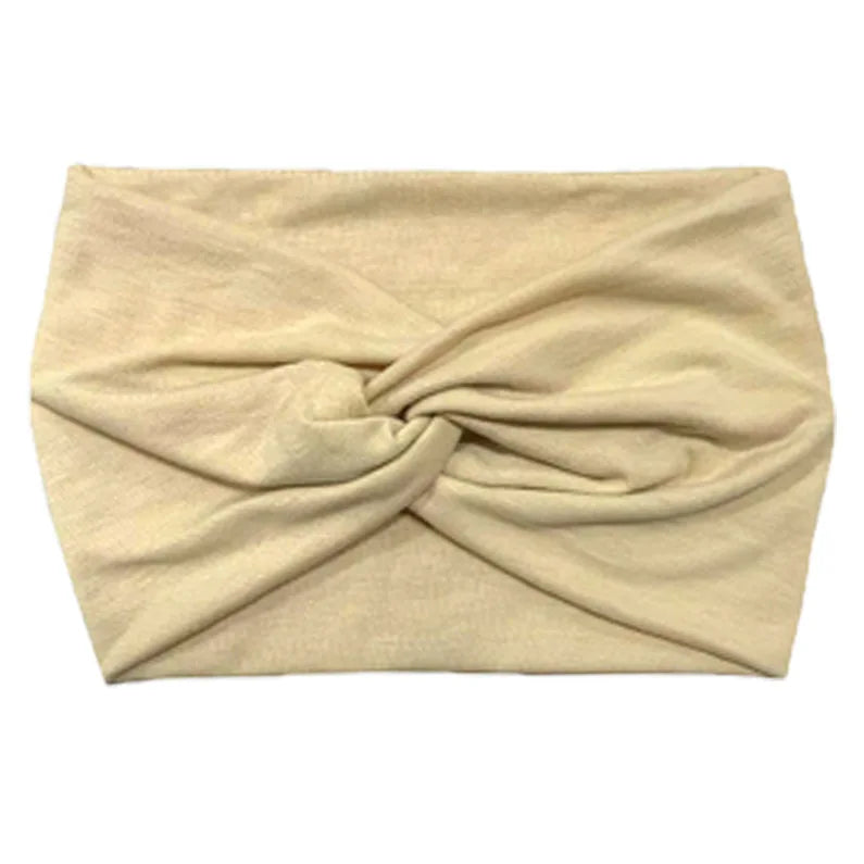 A beige women's elastic sports headband folded and displayed flat.