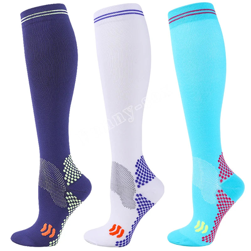 Three pairs of medical grade compression socks in navy blue, white, and cyan