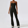A woman wearing a black women's performance tracksuit set, consisting of a tank top and fitted pants.