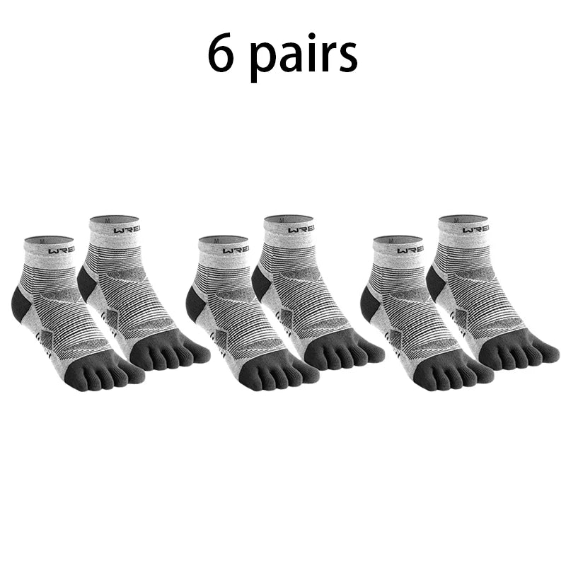 Six pairs of black and white five-finger compression socks laid out.