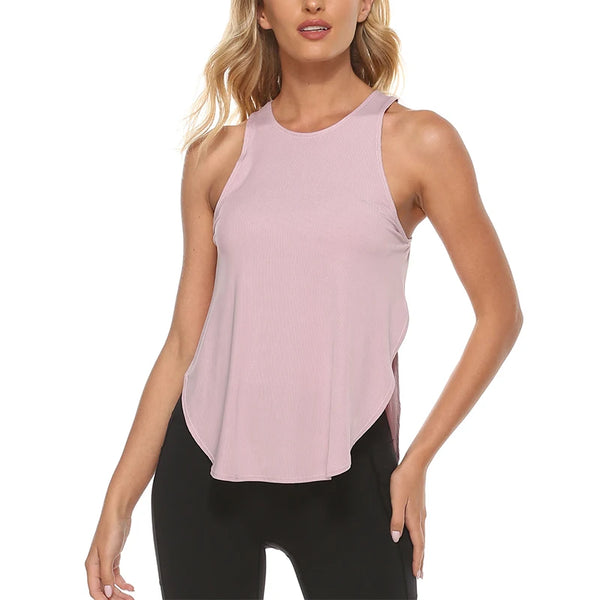 A woman wearing a light pink quick-dry yoga and gym tank top and black leggings.