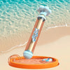 A light blue water gun with a plunger mechanism rests on an orange base near the ocean.