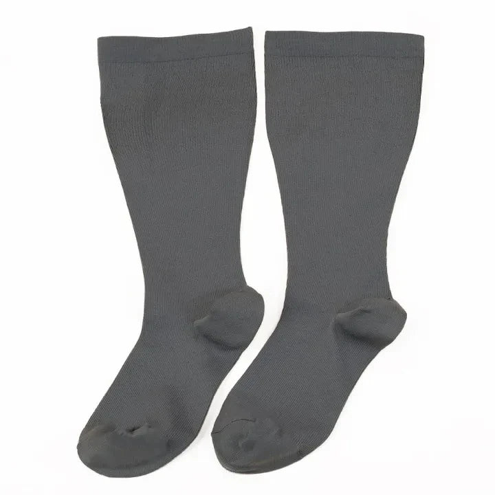 A pair of charcoal gray compression socks for circulation and support.