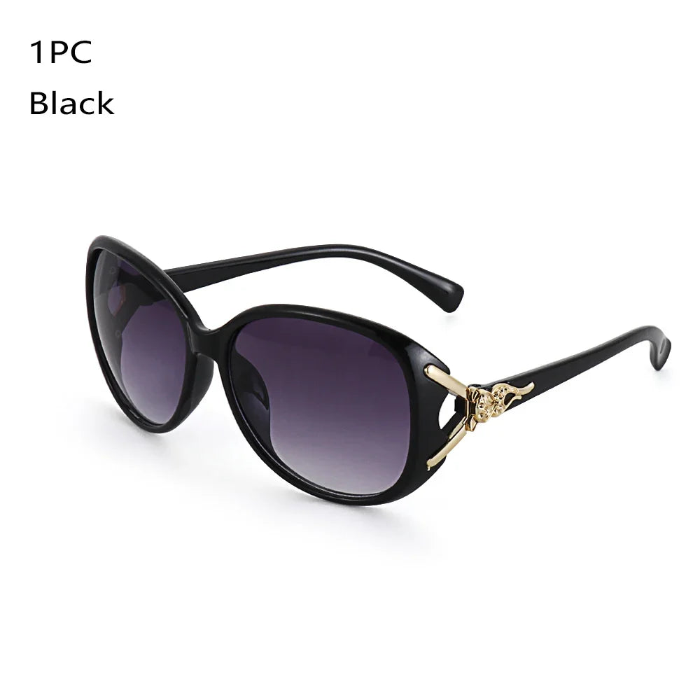 A pair of black vintage oversized retro sunglasses with gold accents.