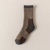 A close-up of a pair of brown and gray merino wool thermal hiking socks.