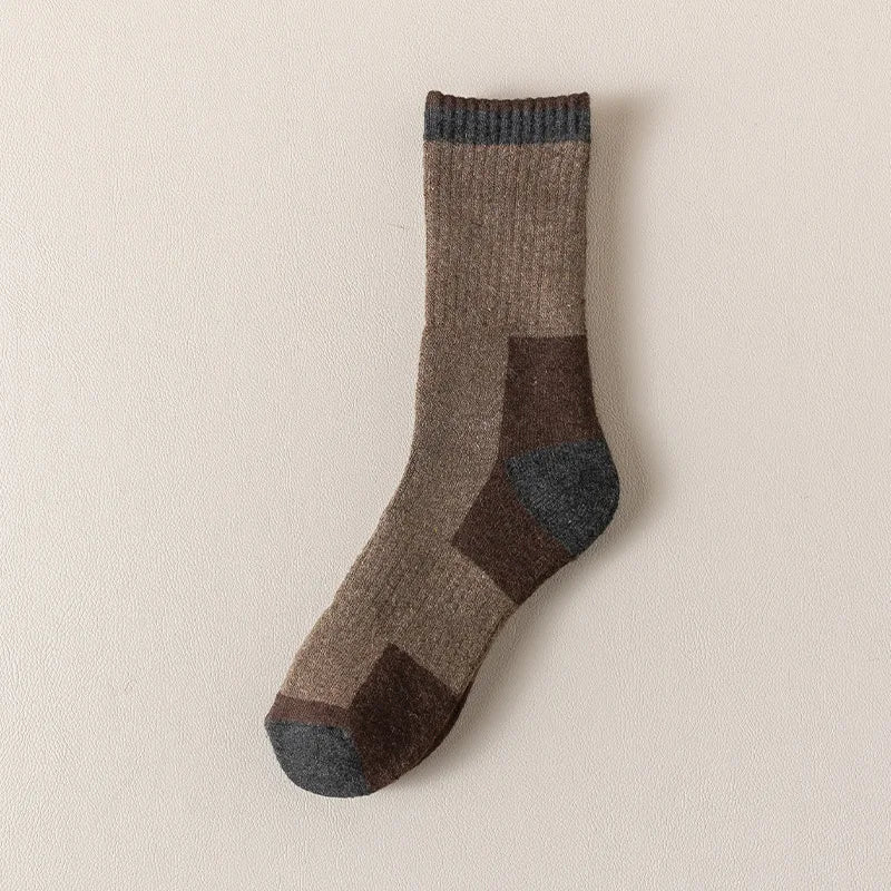 A close-up of a pair of brown and gray merino wool thermal hiking socks.