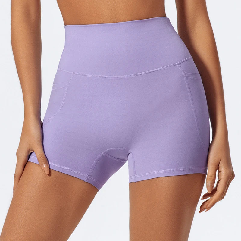 A purple women's high-waist yoga and workout short displayed on a model.
