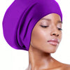 A close-up of a woman wearing a vibrant purple silicone swim cap for long hair.