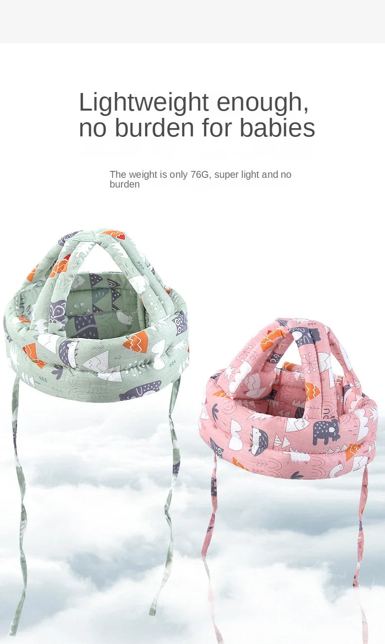A pink and green soft adjustable safety helmet for toddlers displayed against a cloudy sky.