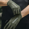 A close-up of olive green cycling performance gloves with ROCKBROS branding being worn on a hand.