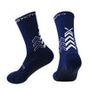 A pair of navy blue athletic sports socks with a chevron pattern