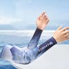A person's arm wearing a blue and white sports sleeve is raised against a bright blue sky and ocean background.