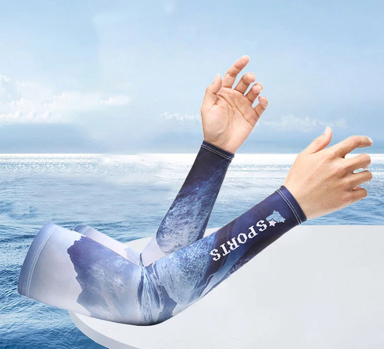 A person's arm wearing a blue and white sports sleeve is raised against a bright blue sky and ocean background.