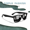 Black retro style sunglasses with dark lenses shown against a teal background.