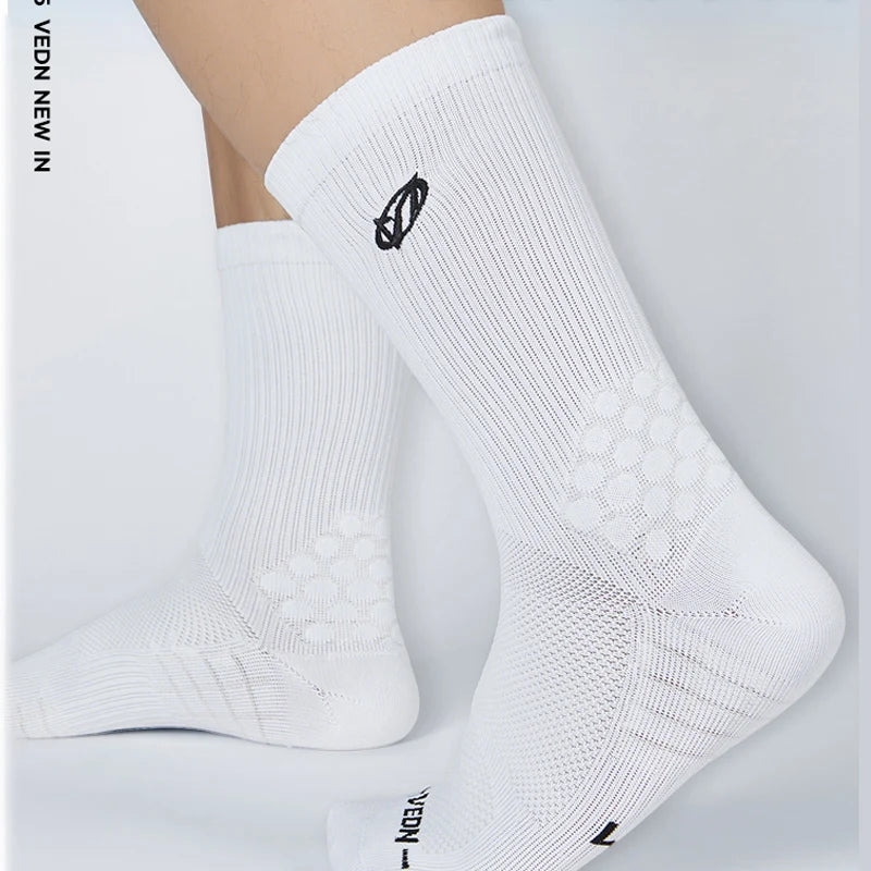White athletic running socks with arch support shown on a foot.