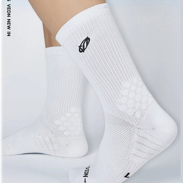 White athletic running socks with arch support shown on a foot.