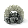A gray satin heatless curling rod headband tied in a voluminous, ruched bow.