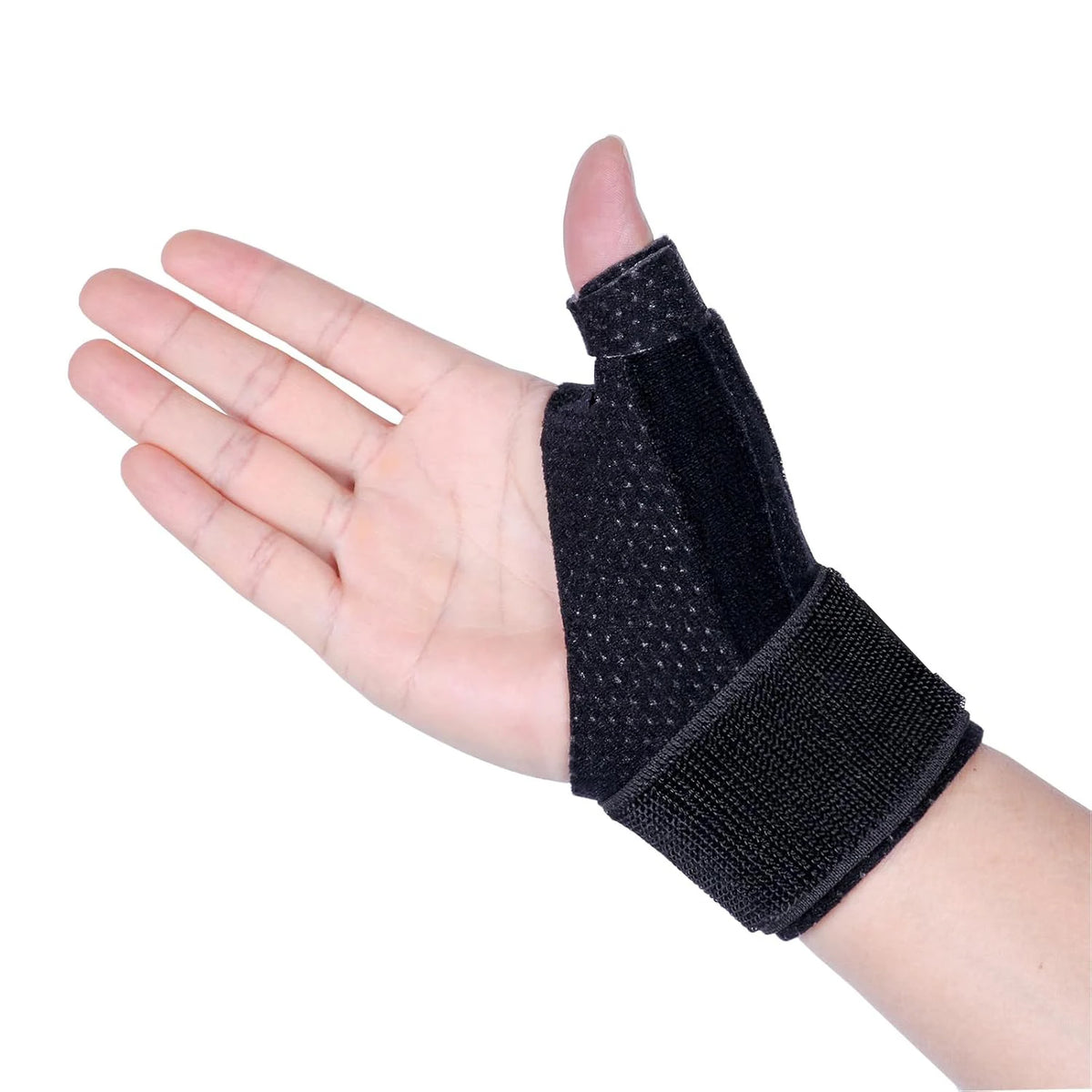 Black reversible wrist brace for thumb pain relief worn on the hand and wrist.