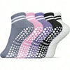 A row of non-slip grip socks in various colors including gray, pink, purple, and black, displayed flat.