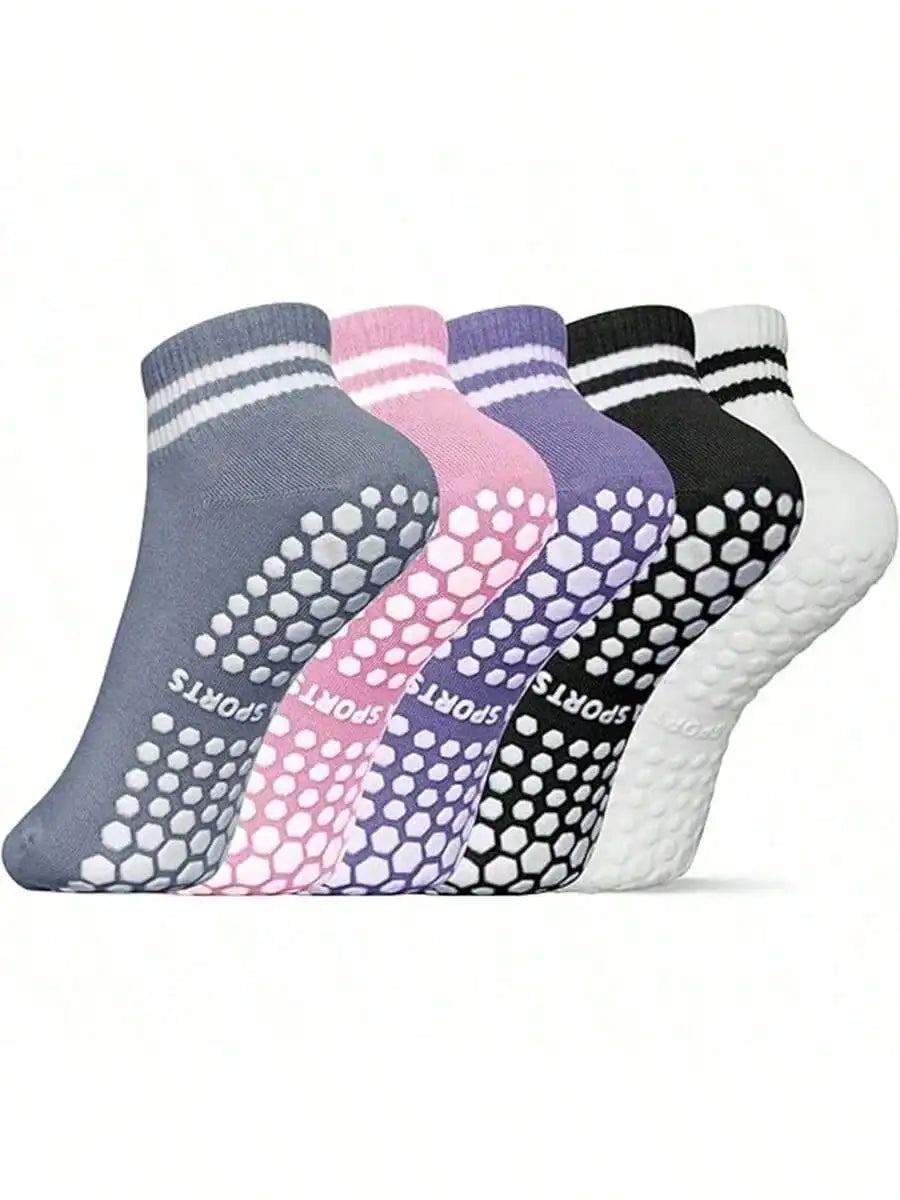 A row of non-slip grip socks in various colors including gray, pink, purple, and black, displayed flat.