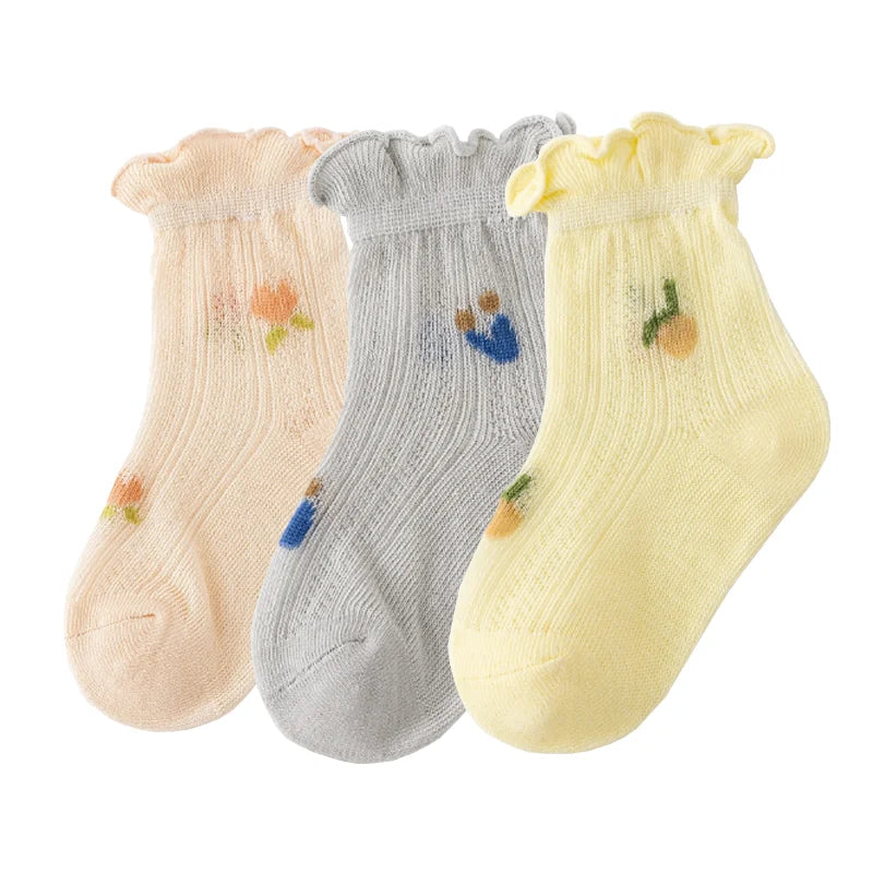 A pack of three thin summer casual baby socks in pink, gray, and yellow.