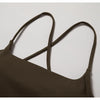 A close-up shot of a dark brown women's performance tracksuit top with thin straps.
