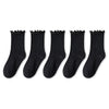 A pack of three black cotton ruffle ankle socks laid out in a row.