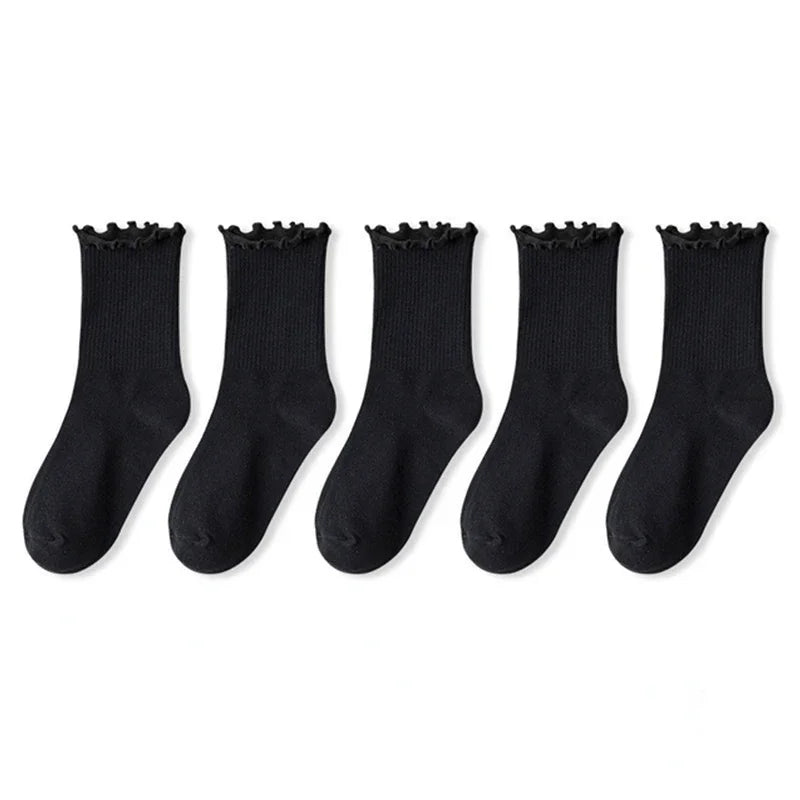 A pack of three black cotton ruffle ankle socks laid out in a row.