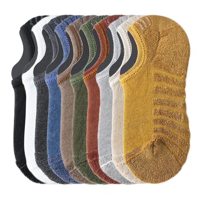 A stack of men's cotton crew socks in various earth tones and neutrals.