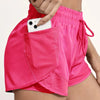 Pink athletic shorts with mesh pockets and a drawstring waistband