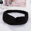 Black fabric headband or hair accessory shown flat on a white surface.