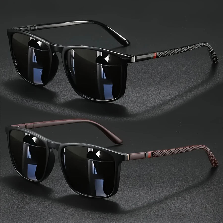 A pair of black vintage square sunglasses with dark lenses and brown accents are displayed on a dark surface.