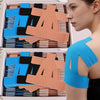 A woman is looking at a box of durable sports elastic patches for shoulder pain relief, featuring blue and orange patches.
